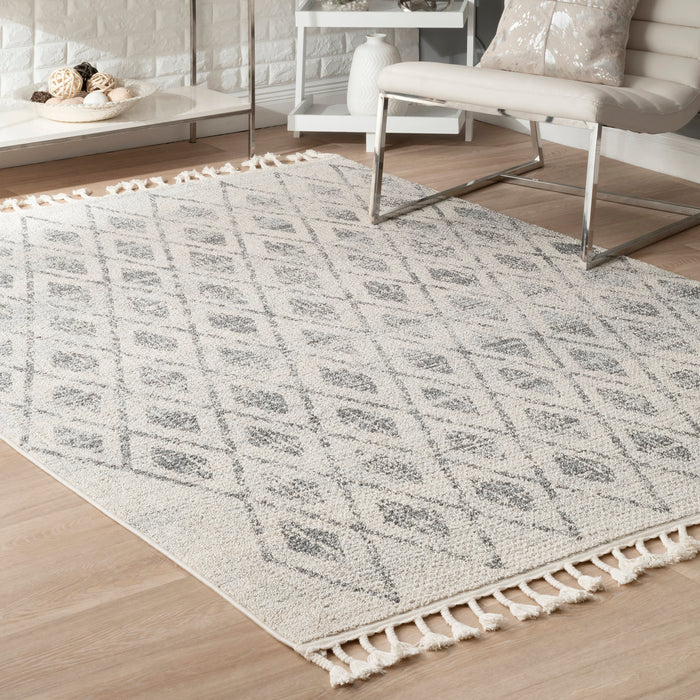 Geometrinen kuviollinen beige matto tupsuilla