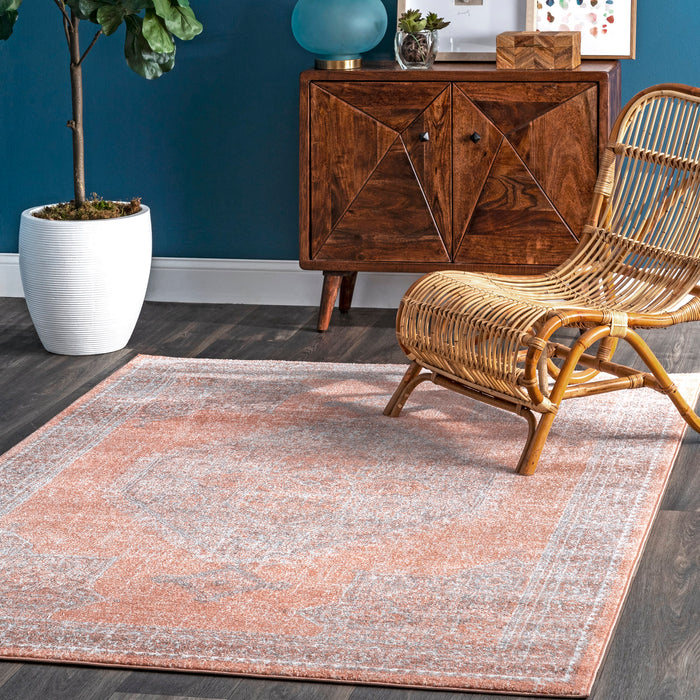 Serrated Emblem Area Rug in Rust Color