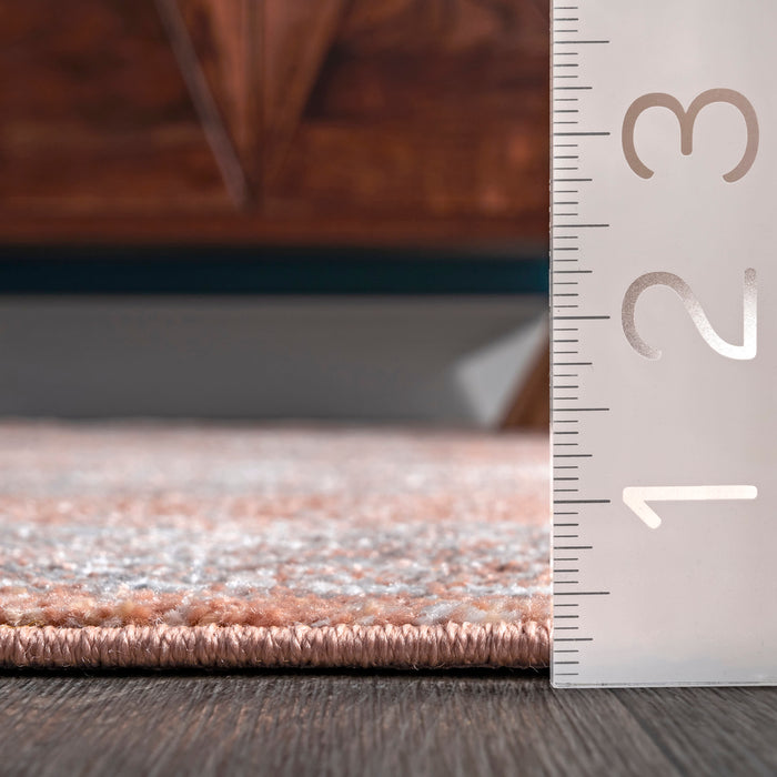 Serrated Emblem Area Rug in Rust Color